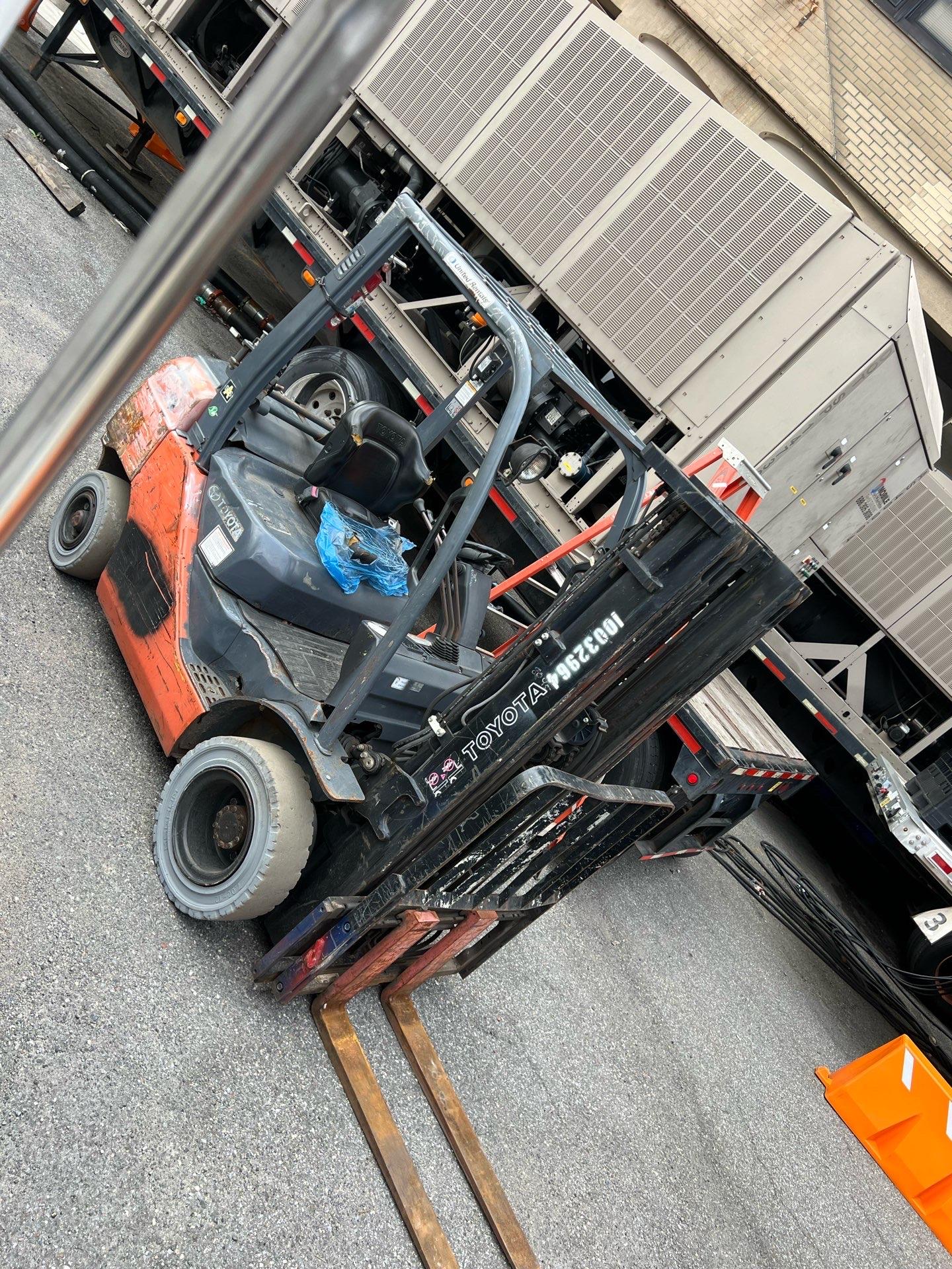 Orange Toyota 5K forklift parked in a yard, photographed from above at an angle